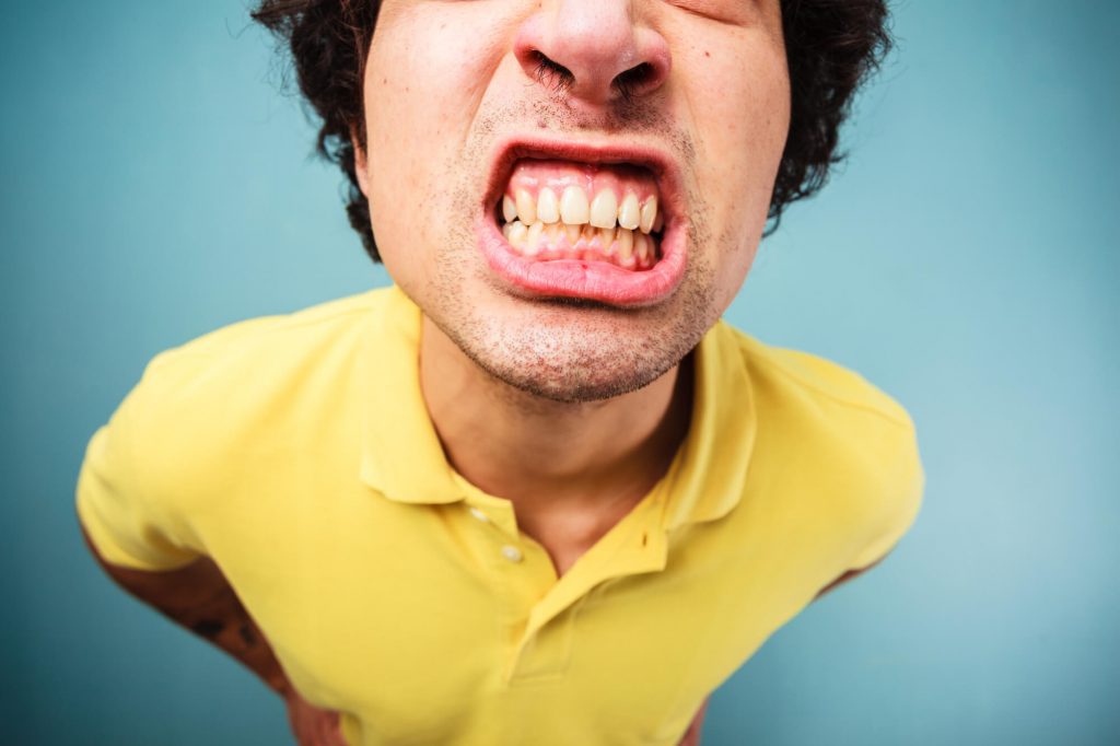 man needing a cosmetic dentist in Raleigh for his yellow stained teeth