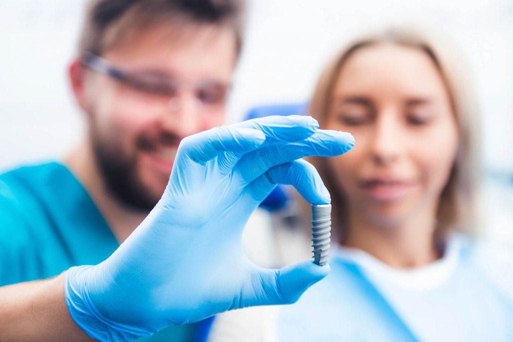 dentist showing dental implants Zebulon