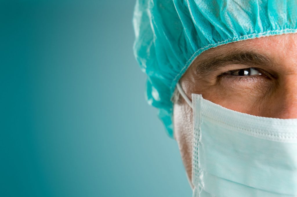 close-up of surgeon's face before dental bone grafting raleigh
