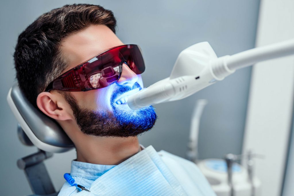 man getting his teeth whitened by a cosmetic dentist in Raleigh  