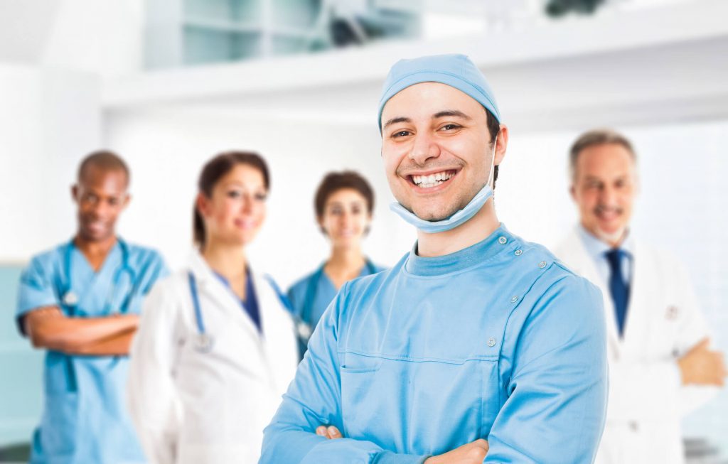 image of a pediatric dentist in Raleigh and his team behind him