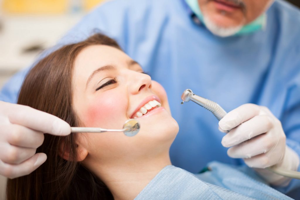 dentist in Zebulon performing dental checkup