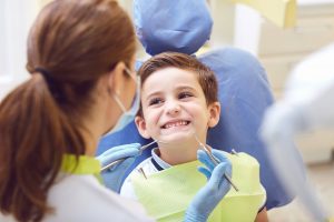 pediatric dentist in Zebulon about to perform an oral exam on a small child Pediatric Dentistry