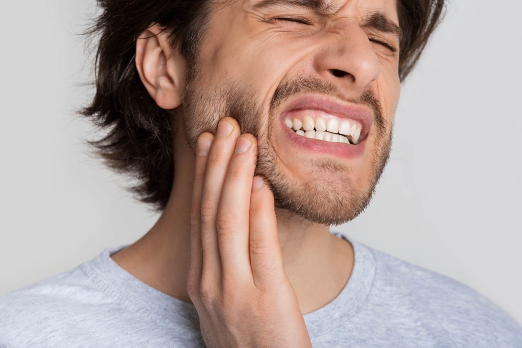 man experiencing tooth pain needing a dentist in Wendell 