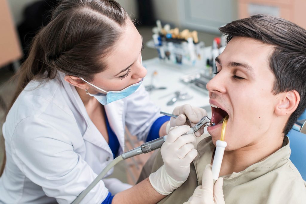 dentist in Wendell cleaning patient's teeth