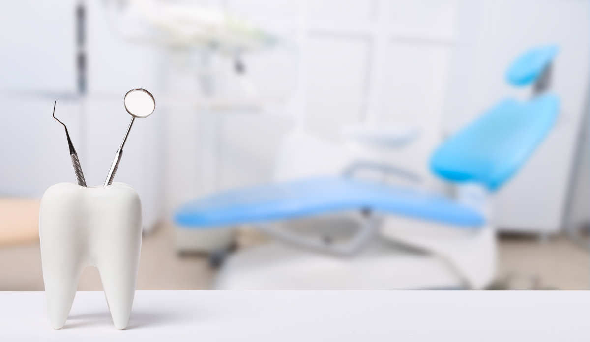 Dental tools in place next to a dental exam chair